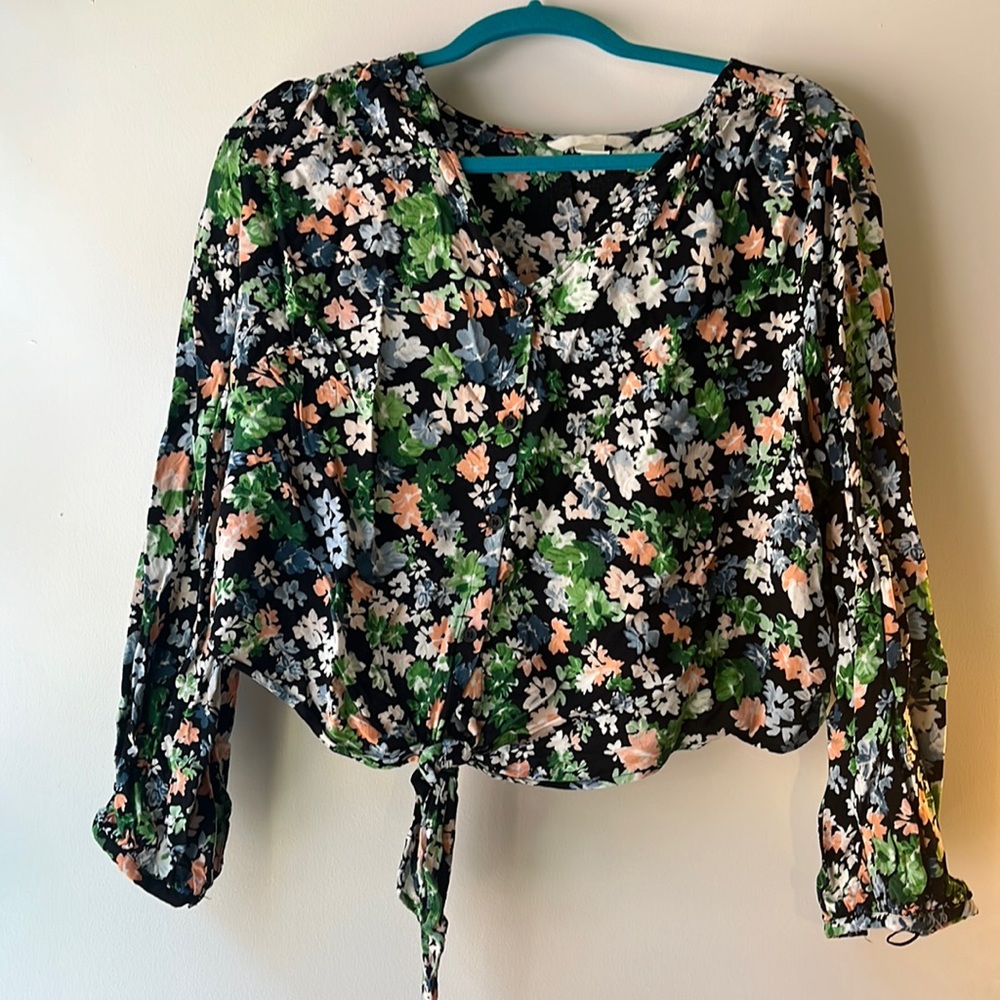 Black floral v- neck shirt with pink, blue, and green flowers and bottom tie